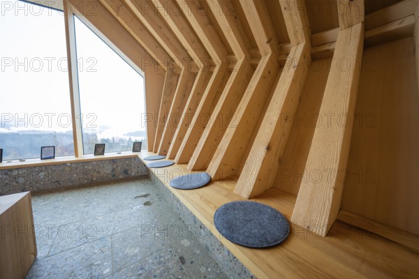 Modern interior with wooden benches and view of the landscape through windows, Sinnraum, Oberreute,