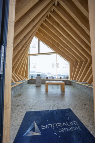 Modern interior with wooden elements and large window with views of nature, Sinnraum, Oberreute,