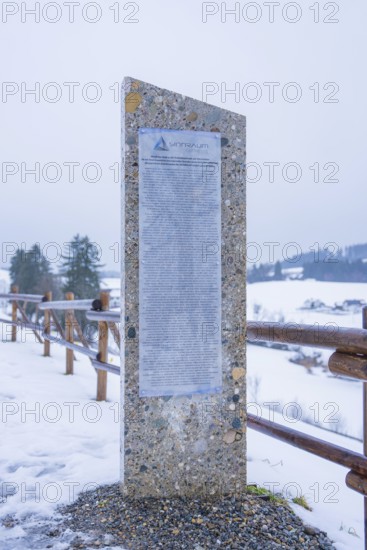 Stone monument with text board on a snowy path in winter, Sinnraum, Oberreute, Allgäu, Bavaria,