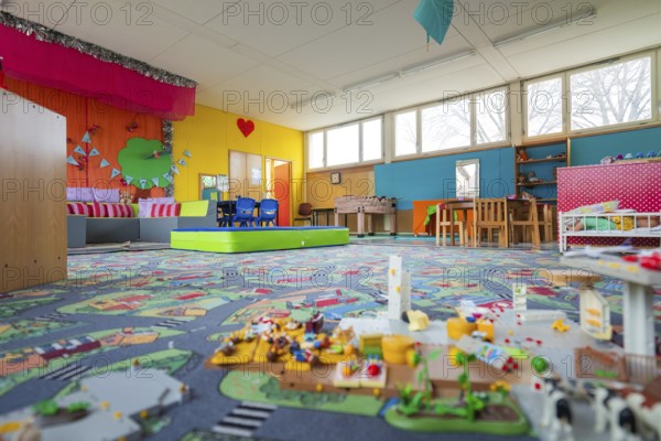 Friendly play area with colorful walls and toys, suitable for lively play, homework supervision,