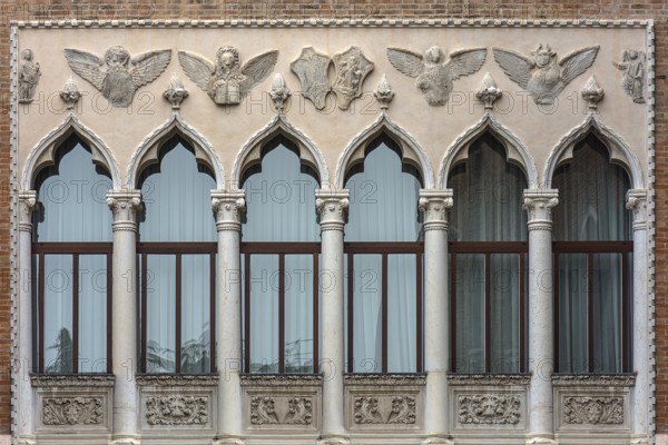 Decorative window front with reliefs of a palazzo, Venice, Veneto, Italy