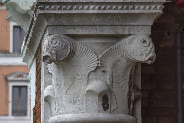 Captain design with fish figures on the arcades of the historic market in Rialto, Venice, Veneto,