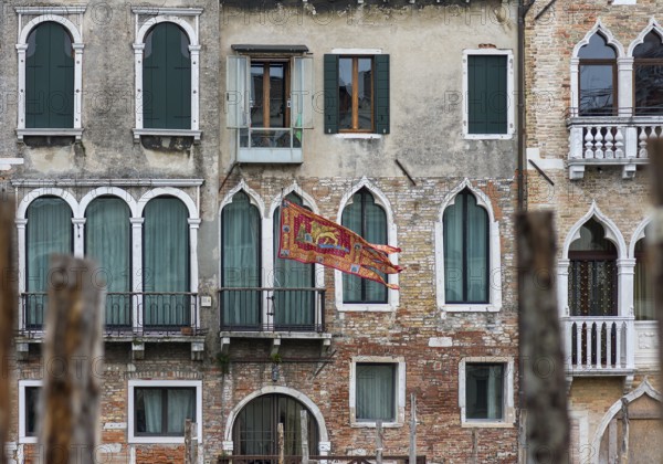 Waving flag of the Republic of Venice on a residential building, Venice, Venice, Italy