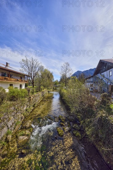 Rote Traun river, fortified bank, riverbed, quarry stone wall, rapids with stones, bushes with