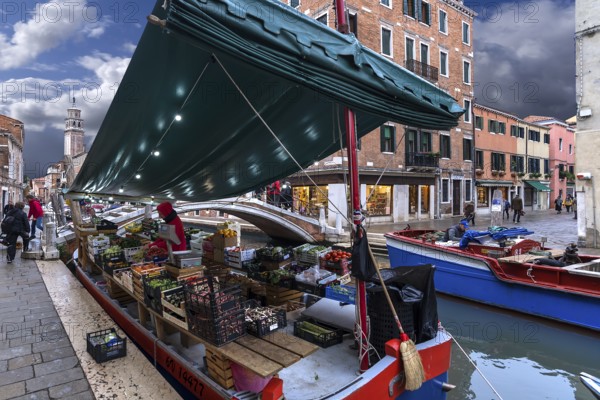 Selling fruit and vegetables from a ship, Venice, Veneto, Italy