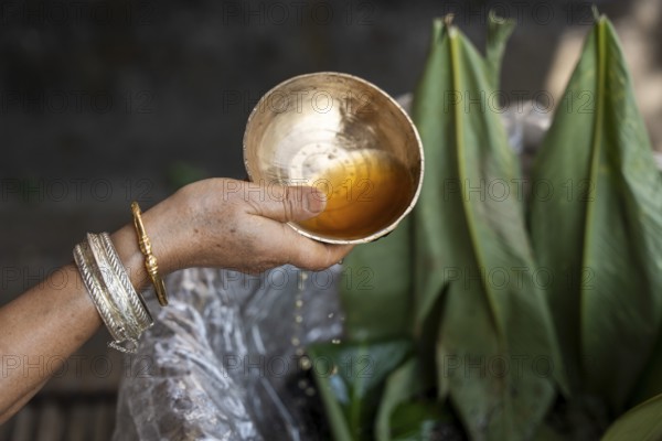 A Mising woman prepares traditional rice beer 'Aapong' during Ali-Aye-Ligang festival in Guwahati,