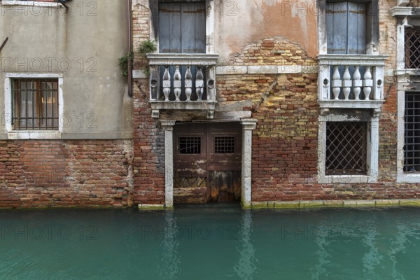 Detail of a house façade in the old town during high tide, Venice, Veneto, Italy
