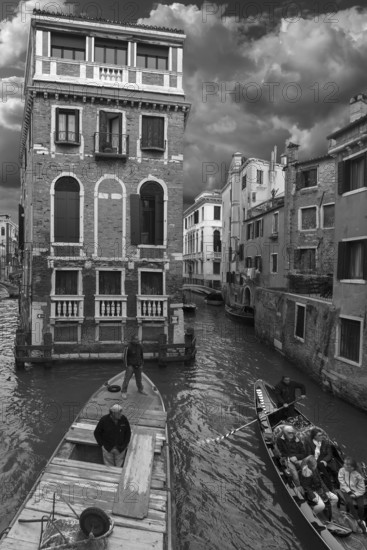 Historic Palazzo Tetta, on the canal, gondola with tourists and workboat, black and white, Venice,