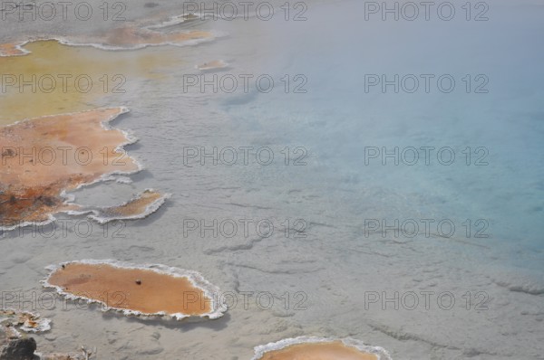 Hot spring with colorful, natural geology consisting of orange and blue, Yellowstone National Park,