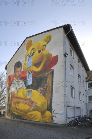 Mural Waldsterben by CASE MaClaim 2024, man with yellow plush toy, bear figure, street art,