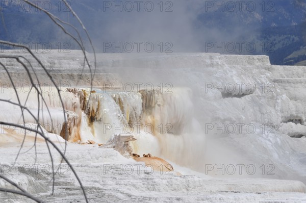 White volcanic deposits, rock formation with steaming waterfall, Yellowstone National Park,