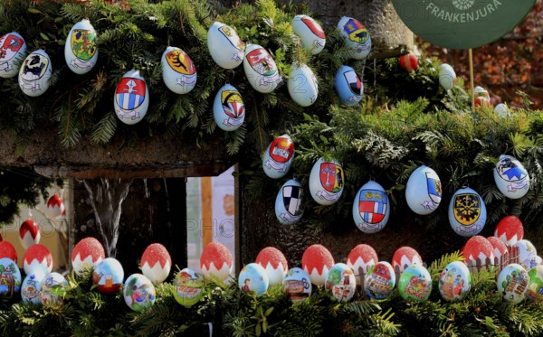 Detail of an Easter fountain in Franconian colors red and white, eggs with coats of arms of the