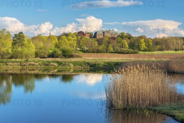 View of a small lake at Burgscheidungen Castle in evening light in spring, Unstrut Valley,
