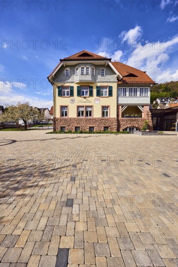 Town hall, commercial building, façade with windows, shutters and façade painting, hipped roof,