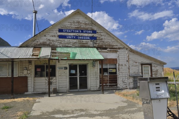 Close-up of a white wooden building, Stratton's Store, with signs and weathered paint, Unity,