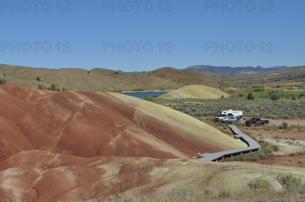 Parking lot and wooden path surrounded by colored hills, John Day Fossil Beds National Monument,