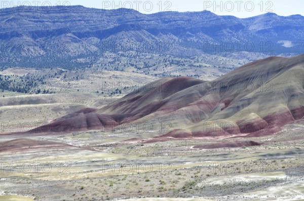 Wide landscape with colorful hills and red stripes in the foreground, John Day Fossil Beds National