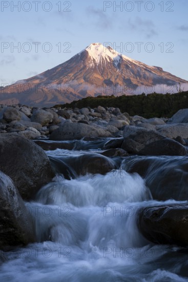 Mount Taranaki in the evening at sunset, in the foreground Stony River (Hangatahua River), Egmont