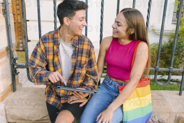 A joyful lesbian couple enjoys a happy moment outdoors, sharing smiles and warmth. They represent