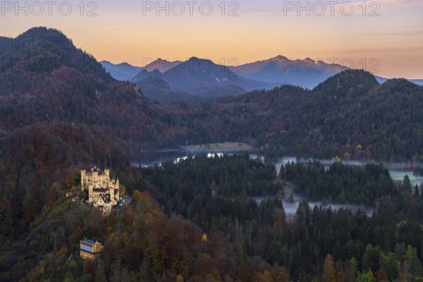Scenic view of Hohenschwangau Castle amidst the vibrant autumn foliage of the Bavarian Alps The