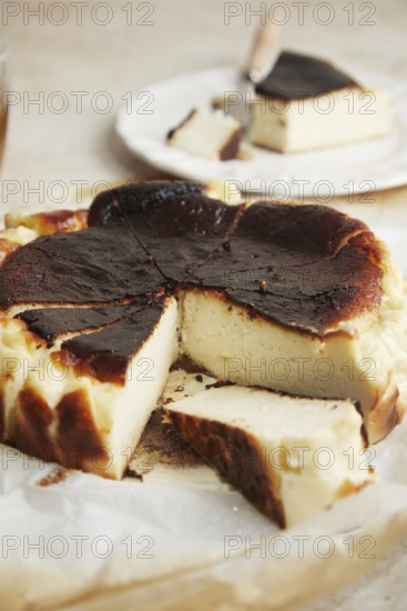 Elegant minimalist photo featuring a slice of San Sebastian cheesecake delicately placed on a