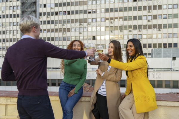 A joyful group of friends celebrating at a rooftop party, clinking glasses and smiling The festive