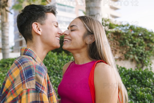 A happy lesbian couple shares a joyful moment, embracing their love and diversity outdoors. Their