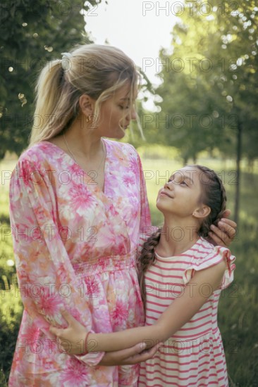 A mother and her daughter gaze at each other with love and understanding in a sunlit park Their