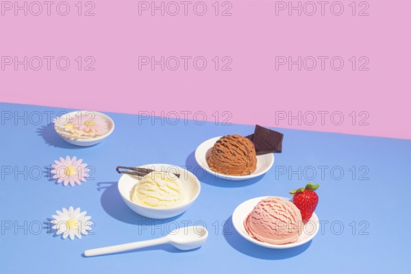 Various flavors of ice cream in white dishes, presented against a striking pink and blue