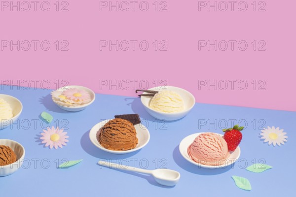 Vibrant image featuring bowls of various ice cream flavors on a dual-tone pink and blue background.
