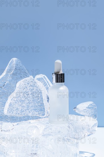 A serene image showcasing a clear serum bottle placed on an icy sculpture, illuminated with a soft