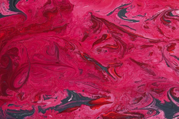 A striking abstract marble texture featuring vivid shades of acrylic red and pink, intertwined with
