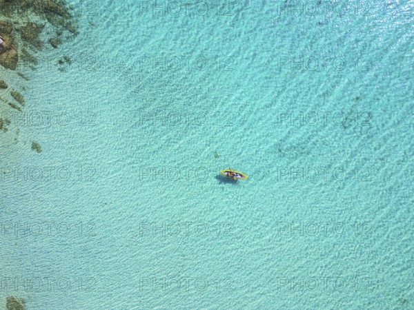 A stunning aerial view of Diaporos Island in Greece, showcasing crystal-clear turquoise waters with
