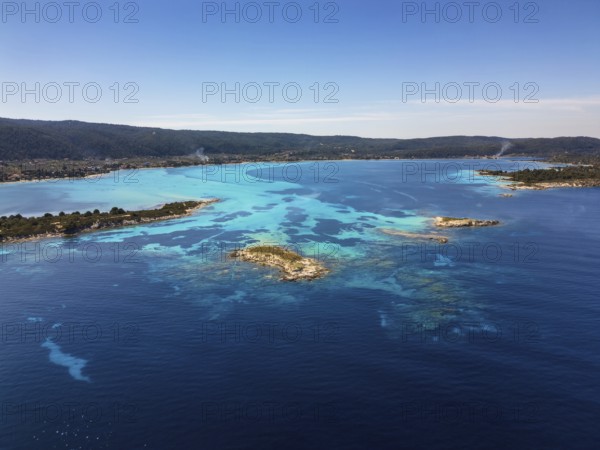 Drone view of Diaporos Island and Karydi Beach in Greece, showcasing crystal-clear turquoise