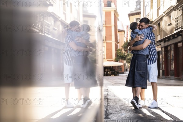 A loving embrace between a gay couple on the charming streets of Madrid. The scene captures a