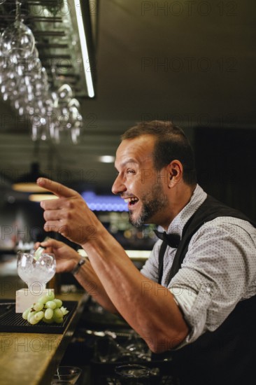Professional bartender crafting cocktails in a chic bar. The atmosphere is lively and