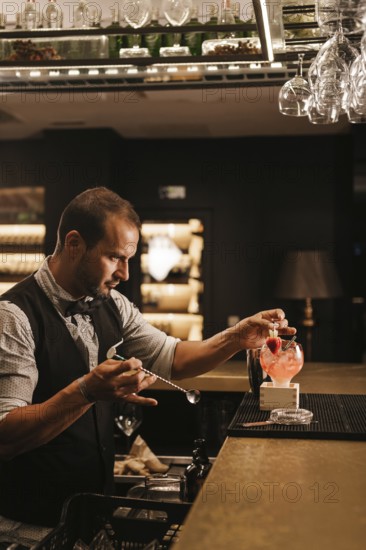 A skilled bartender expertly prepares a cocktail in a stylish bar, showcasing precision and