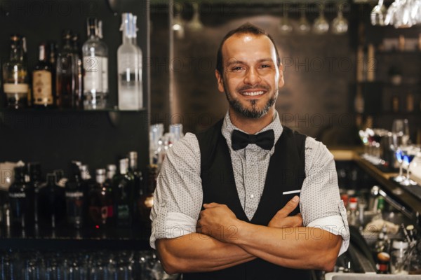 A professional bartender stands confidently in a stylish cocktail bar, surrounded by a selection of