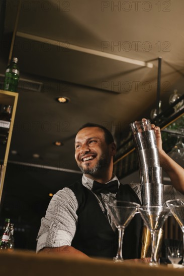 A skilled bartender joyfully mixes cocktails at an elegant bar, showcasing expertise and charm.