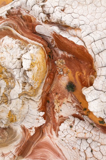 This striking aerial image captures the complex patterns of red and white rock formations. The