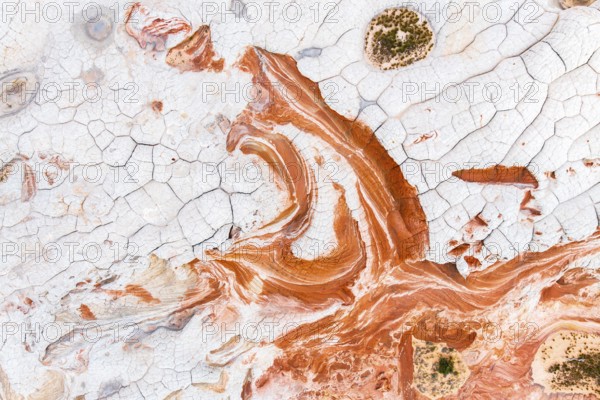 This stunning aerial photograph captures the intricate details of abstract red and white rock