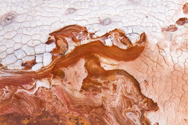 Vibrant and textured aerial view of abstract red and white rock formations, showcasing intricate