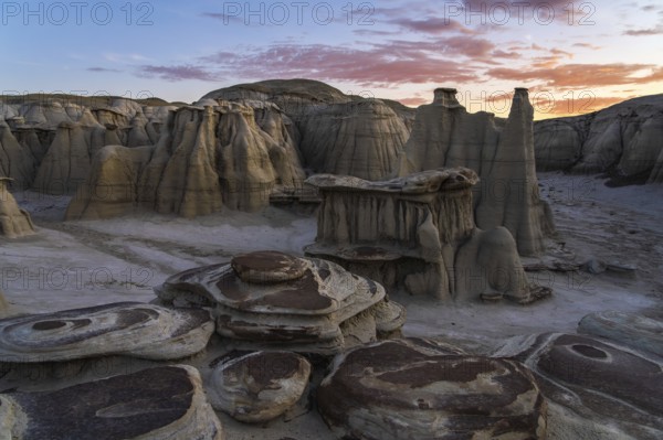 Captivating sunset view of the surreal, eroded rock formations in the Bisti/De-Na-Zin Wilderness,