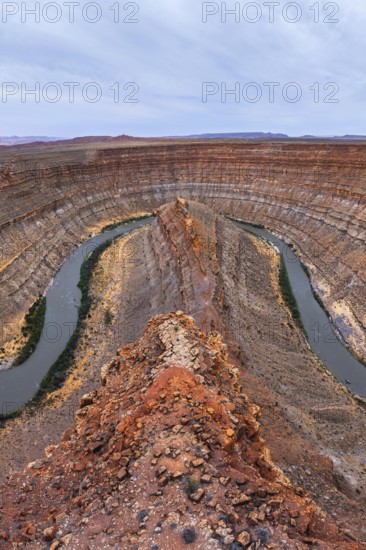 Stunning aerial view of a San Juan canyon featuring a winding river carving through layered rock