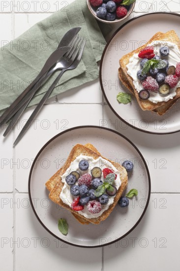 Top view of delicious breakfast setup featuring toast slathered with cream cheese and topped with