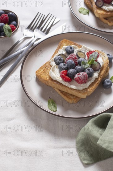 Delicious serving of toast topped with cream cheese and a generous selection of fresh berries