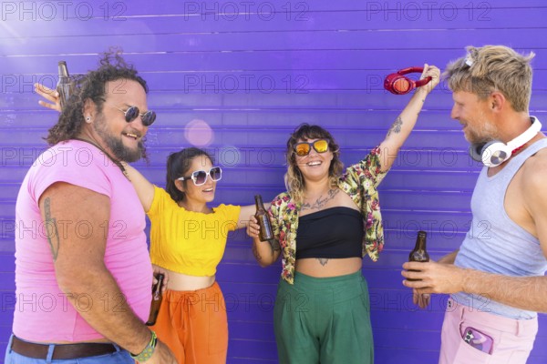 Vibrant group of LGBTQIA+ friends enjoying a sunny day together. They share laughter, drinks, and