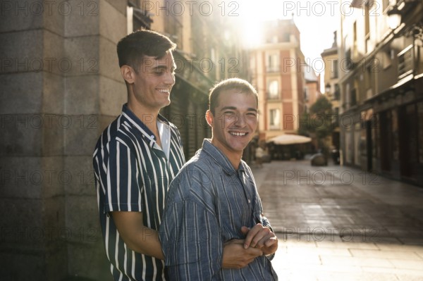 A joyful gay couple embraces while strolling down the sunlit streets of Madrid. Capturing love,