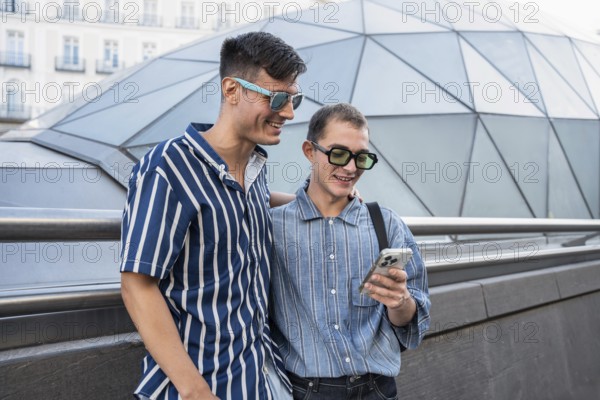 A cheerful gay couple enjoys a day out in the vibrant streets of Madrid, capturing moments on their