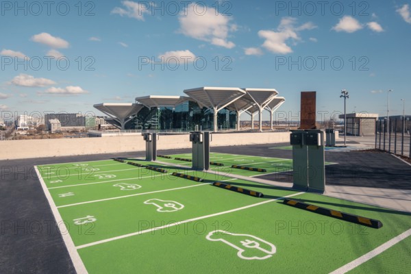 View of a new transport hub in Valdebebas, Madrid, featuring parking with electric vehicle charging